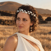 Charger l'image dans la galerie, Mariée portant une demi-couronne de feuilles blanches en porcelaine froide sur le front, coiffure relevée et robe blanche.