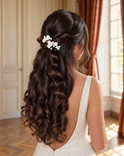 Charger l'image dans la galerie, Épingles à cheveux avec fleurs blanches en porcelaine froide et perles d'eau douce,  portées sur une demi-attache de mariée aux cheveux longs et ondulés.