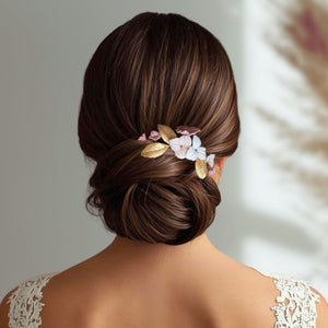Peigne de mariage avec fleurs rose, blush et ivoire et feuilles dorées en porcelaine froide pour coiffure de mariage bohème ou champêtre.
