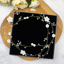 Charger l'image dans la galerie, Détail d’une liane florale de mariage en fil doré avec fleurs blanches modelées en porcelaine et fines branches de perles